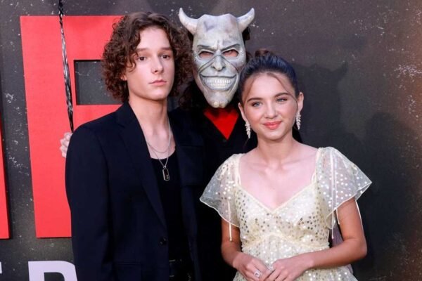 Mason Thames smiling on the red carpet showing his full height.