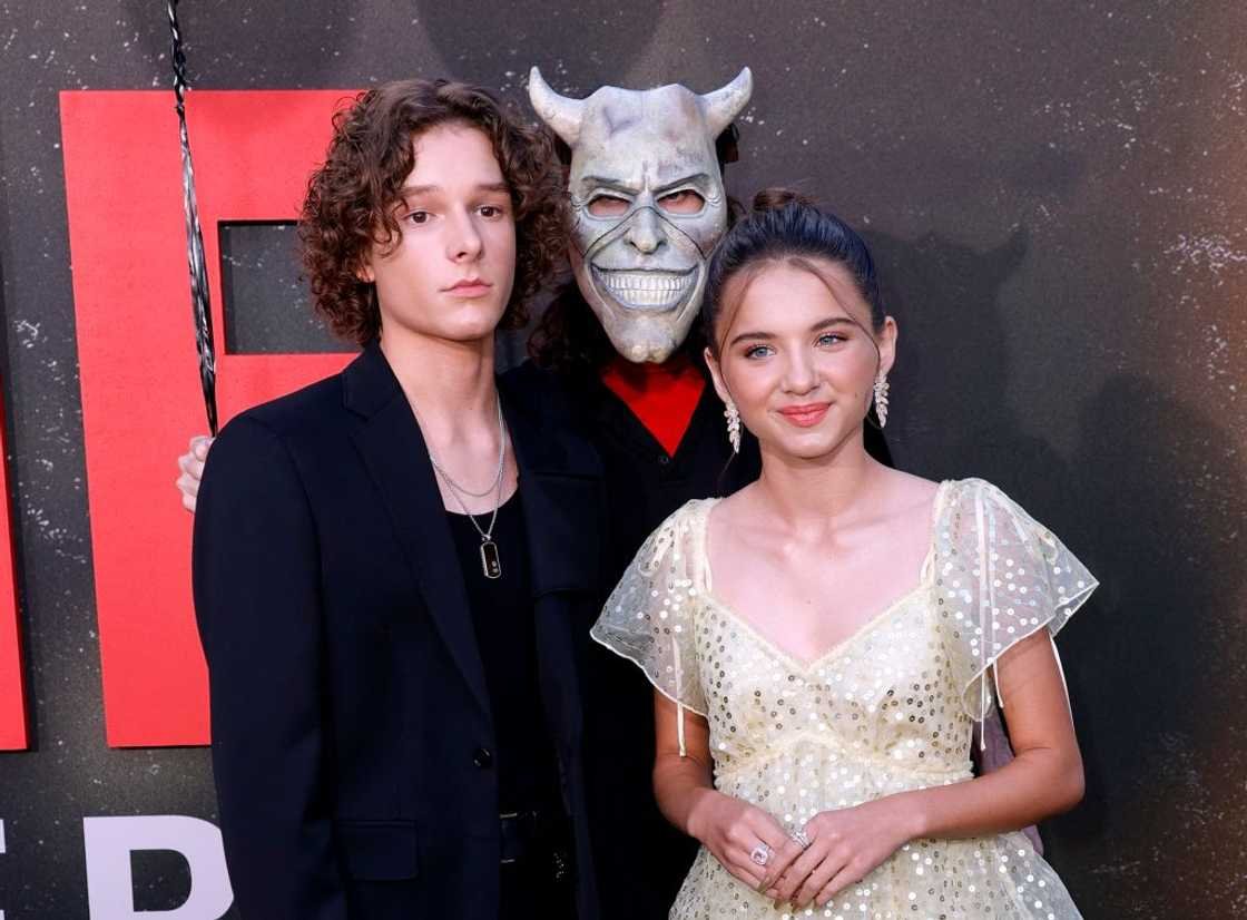 Mason Thames smiling on the red carpet showing his full height.